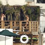 First pic of Cara Delevingne sunbathing topless on a balcony