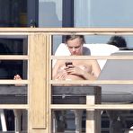 Third pic of Cara Delevingne sunbathing topless on a balcony