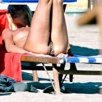 Third pic of Stefania Orlando sunbathing topless on a beach