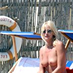Fourth pic of Stefania Orlando sunbathing topless on a beach