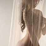 Second pic of Naked Lily XO behind a sheer curtain.