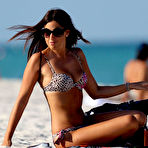 First pic of Claudia Romani shows cleavage in leopard bikini on the beach
