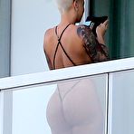 Third pic of Amber Rose flashing her ass on a balcony