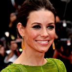 First pic of Evangeline Lilly posing in short dress shows her long legs at premiere