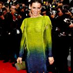 Third pic of Evangeline Lilly posing in short dress shows her long legs at premiere