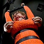 Second pic of SexPreviews - Sharon Darling in orange is rope bound and double fucked by maledoms