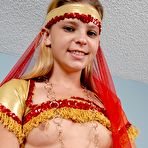 Second pic of Skinny Destiny Garnet in red ethnic costume gives a close-up of her hairless pussy