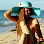 Second pic of Blue eyed brunette Nicole K shows her smelting hot body on a desert island beach.