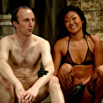 Fourth pic of Pale skinned nude slave man John getting used by tan skin slender asian domme Lucy Lee