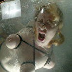 Fourth pic of Tied prisoner Adrianna Nicole licks the floor clean before getting dunked in a water tank