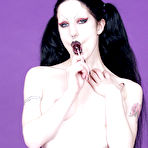 Third pic of Raven haired pigtailed goth chick Fetus de Milo with lollipop poses topless in pantyhose