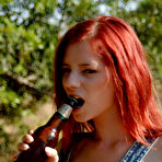 First pic of Naked redhead Ariel posing outside with beer and a bike