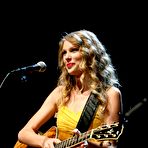 Second pic of Taylor Swift in yellow dress at Country Music Hall Of Fame stage