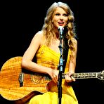 Third pic of Taylor Swift in yellow dress at Country Music Hall Of Fame stage