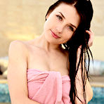 Fourth pic of Pretty-looking chick with perky tits shows her pussy next to the pool - aMetart.com