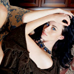Third pic of Blue-eyed brunette with wavy hair and a brown throw posing on a chair - aMetart.com