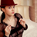 Second pic of Ponytailed brunette in a bodysuit hiding her pussy with a fedora - aMetart.com