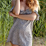 First pic of Busty redhead in a dress flashes her juicy pussy on a sandy beach - aMetart.com