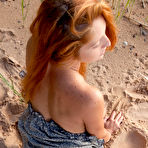 Second pic of Busty redhead in a dress flashes her juicy pussy on a sandy beach - aMetart.com