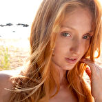 Fourth pic of Busty redhead in a dress flashes her juicy pussy on a sandy beach - aMetart.com
