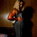 Third pic of Blonde bodybuilder Colette Nelson in dress and nylons shows of her heavy muscles