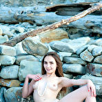 Third pic of Perky tits beauty and pale skin poses fully naked at the beach and shows her nice pink slit and tits. pics