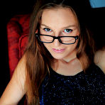 Second pic of Nude Nerdy Sofi Shane flaunts her hairy snatch while reading on the chair.