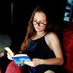 Third pic of Nude Nerdy Sofi Shane flaunts her hairy snatch while reading on the chair.