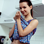 Fourth pic of Nude Iva strips in the kitchen as she flaunts her petite body.