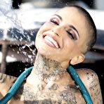 Third pic of Sexy Penthouse tattoo girl Leigh Raven gets wet at the wrecking yard