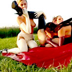 Second pic of Salma de Nora and two more latex lesbians have fun in the open air on a rubber blanket