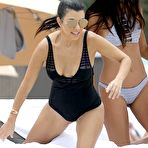Fourth pic of Kourtney Kardashian in black swimsuit on a beach