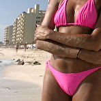 Third pic of Sunbathing Lori Anderson in shades and pink bikini gives a close-up of her arm hair 
