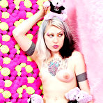 Fourth pic of Gothic teen Mad Sophie with heavy make-up shows off her puffy pierced tits playing with plush toys