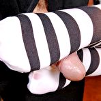 Fourth pic of Naughty college girl Angel Pink gives a sensuous footjob in striped black and white stockings