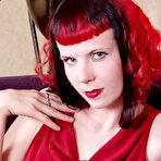 First pic of Pale skinned redhead Szandora strips out of her long red dress and exposes her nude body