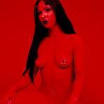 Third pic of Naked crazy brunette Lydia Lashes with pierced tits and belly button poses in red atmosphere