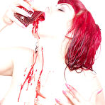 Fourth pic of Naked Ondine with red hair and pale skin drinking blood in the bathroom