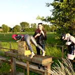 First pic of Bimba Sawacco in mask and latex suit gets dominated by Susi M and Lady K outdoors