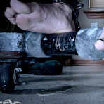 Second pic of SexPreviews - Alex More petite brunette is metal bound to rolling device for kitchen tasks