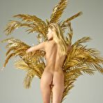 First pic of Candice B posing nude by a big golden plant