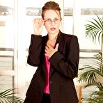 First pic of Bespectacled secretary Helena in black nylon stockings flashes her bush when doing striptease