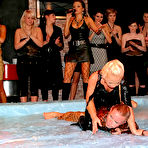 Second pic of Clothed wrestlers Sharka Blue and Sarah Zafari getting oil drenched as they wrestle in oil