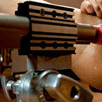 Third pic of Oiled up busty blonde Lylith Lavey takes robotic dildo in the middle of the gym