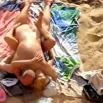 Second pic of Blonde nudist woman and horny bald dude caught having sex on public beach
