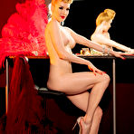 Third pic of Miss Miranda poses in a burlesque costume and feather fans