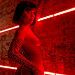 Fourth pic of Precious Milan strips nude in front of bright neon lights