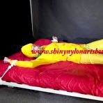 First pic of Shinynylonartsbound | Watching sexy Pia being tied and gagged with ropes on a bed and a clothgag wearing sexy yellow shiny nylon rainwear (Video)