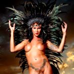 Second pic of Tatted transgirl Danni Daniels models an indigenous headdress while naked in heels | TRANS.pics