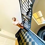 Third pic of Katerina Hartlova posing in the stairwell in her boots and foxtail